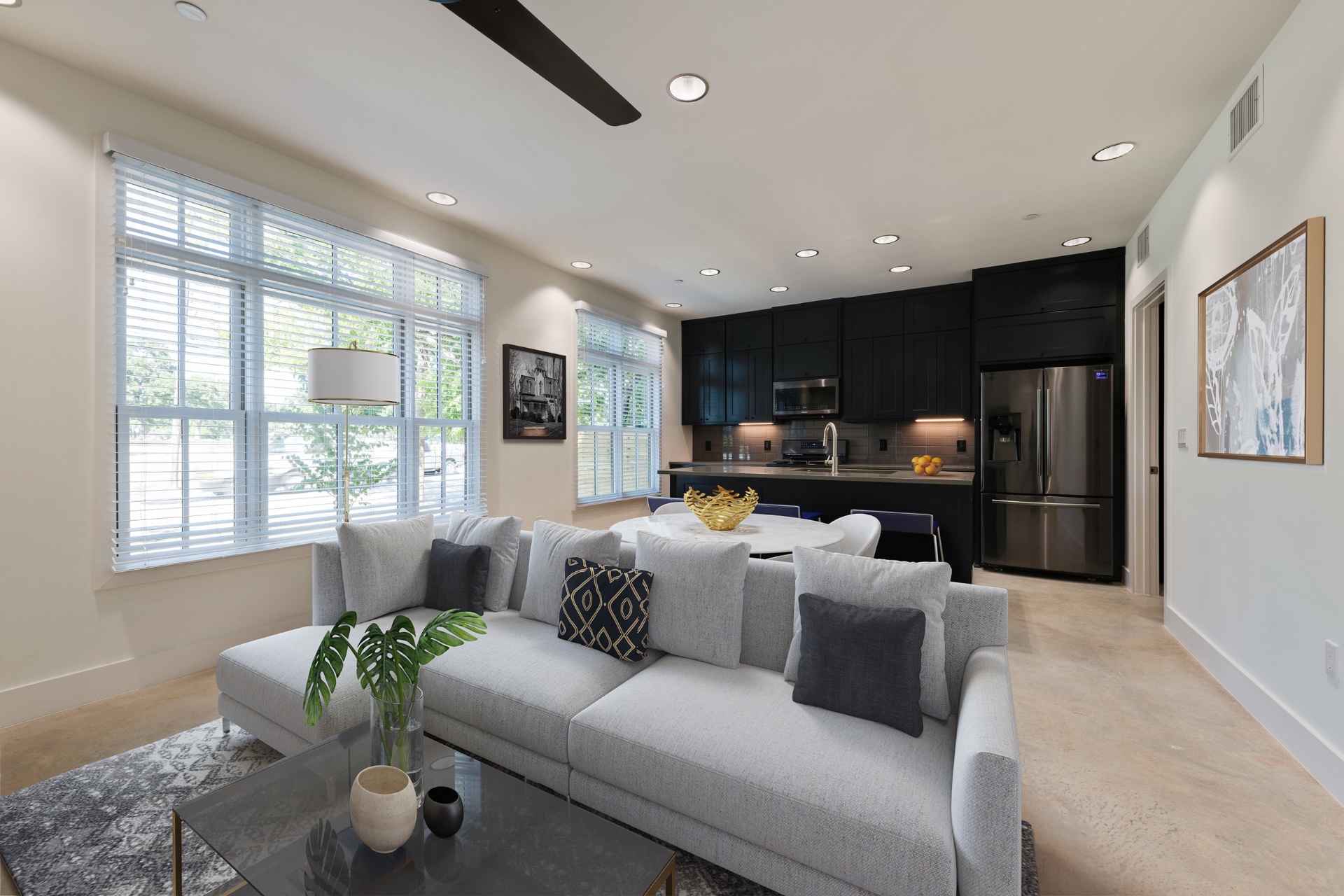 Unit 2-1 living room with sectional and open kitchen